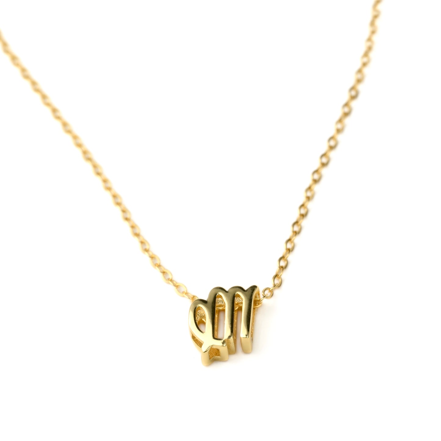 Gold virgo necklace on a white background