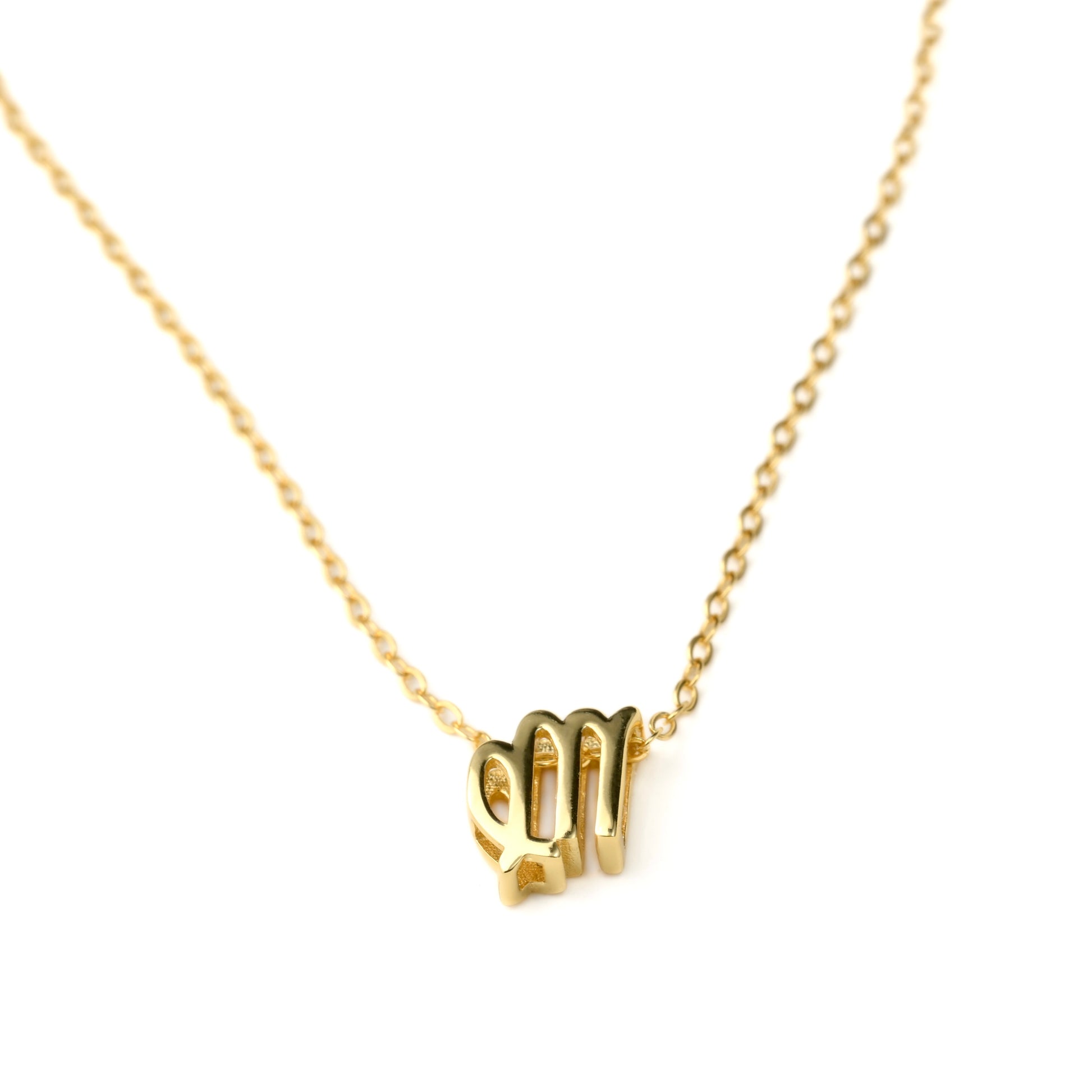 Gold virgo necklace on a white background