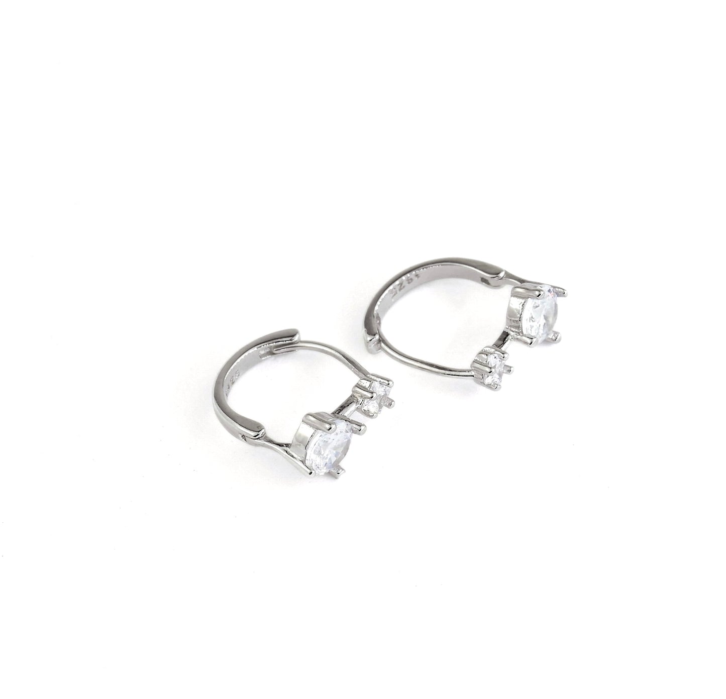 silver huggies with clear CZ on a white background