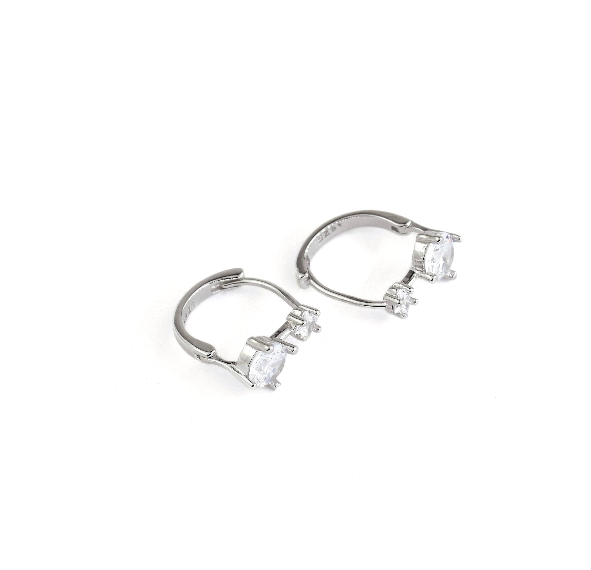 silver huggies with clear CZ on a white background