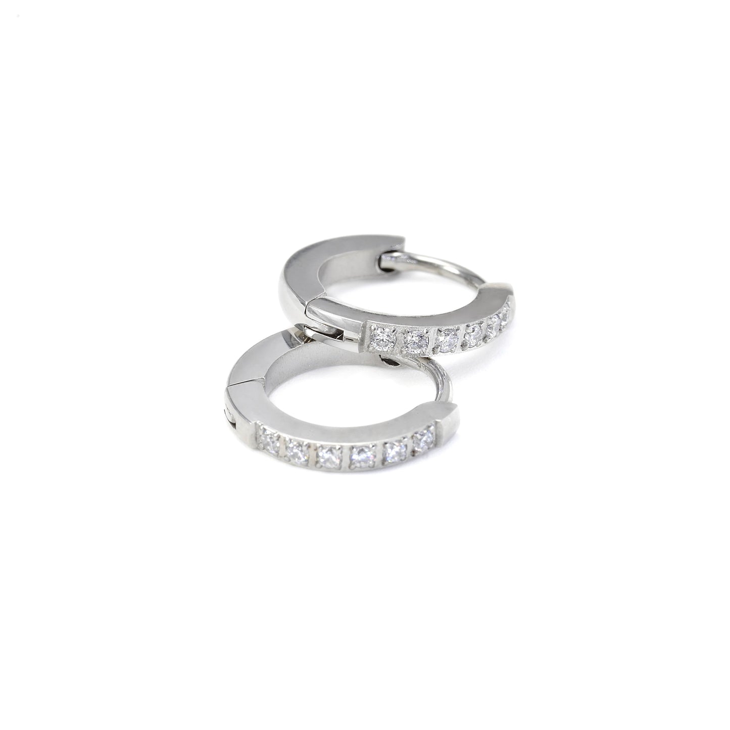 Silver hoop earrings with small diamonds on a white background