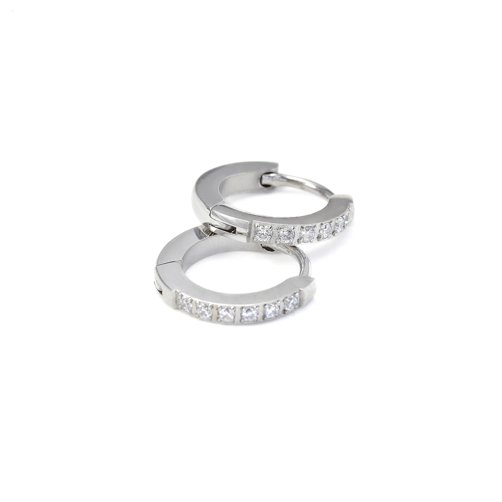 Silver hoop earrings with small diamonds on a white background