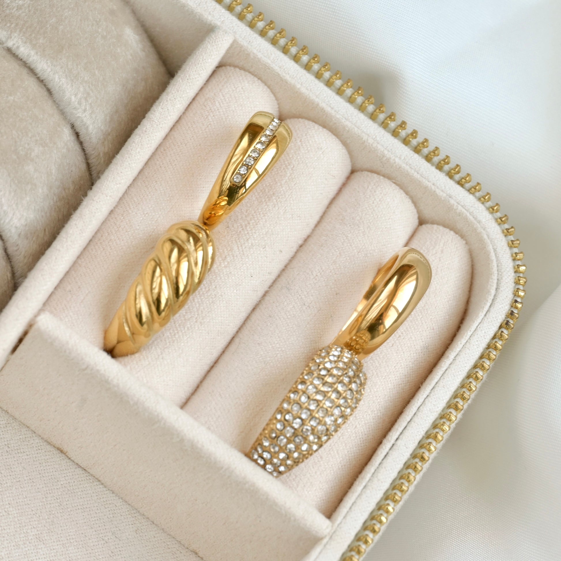 Gold rings with diamond accents in a jewelry box
