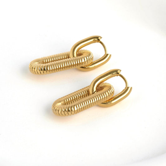 Pair of gold double hoop earrings on a white background