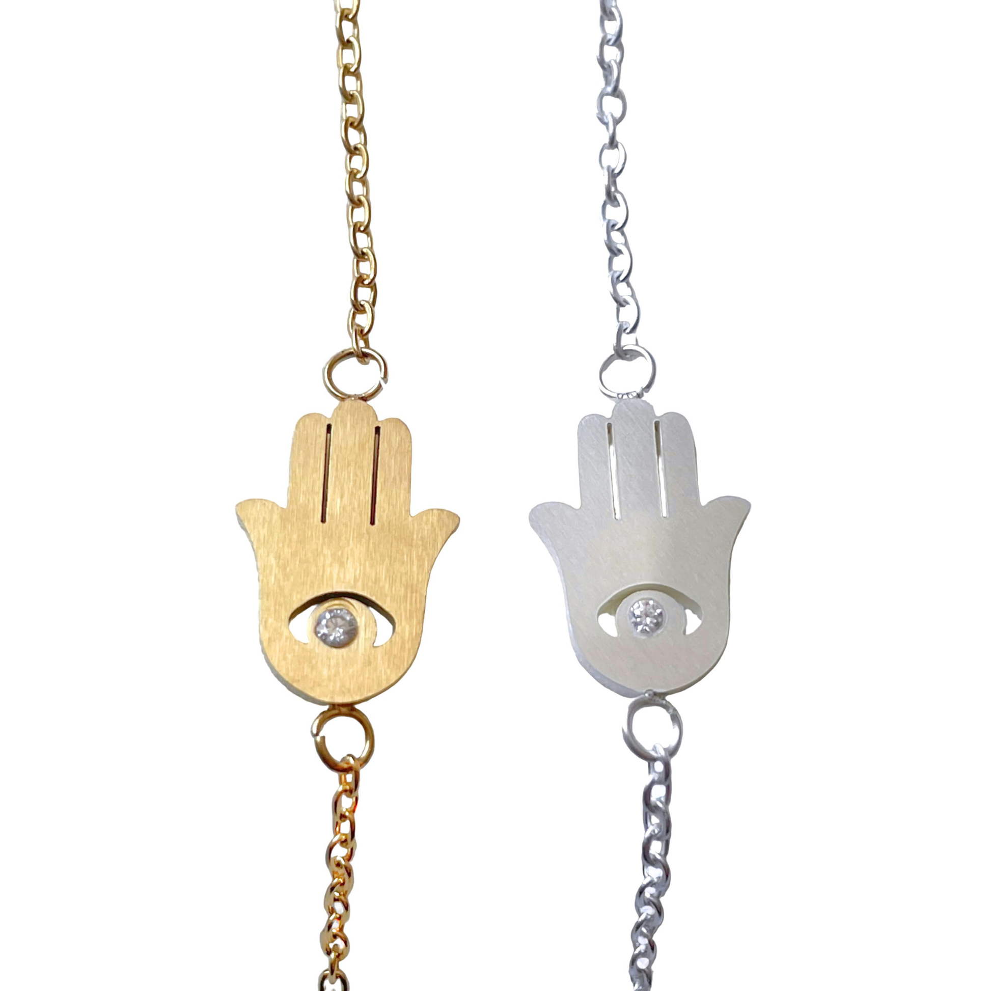 Gold and silver Hamsa hand bracelets  with embedded stones on a white background