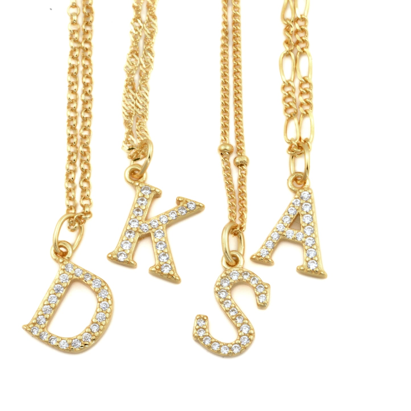 Gold necklaces with pave CZ initial charms on a white background