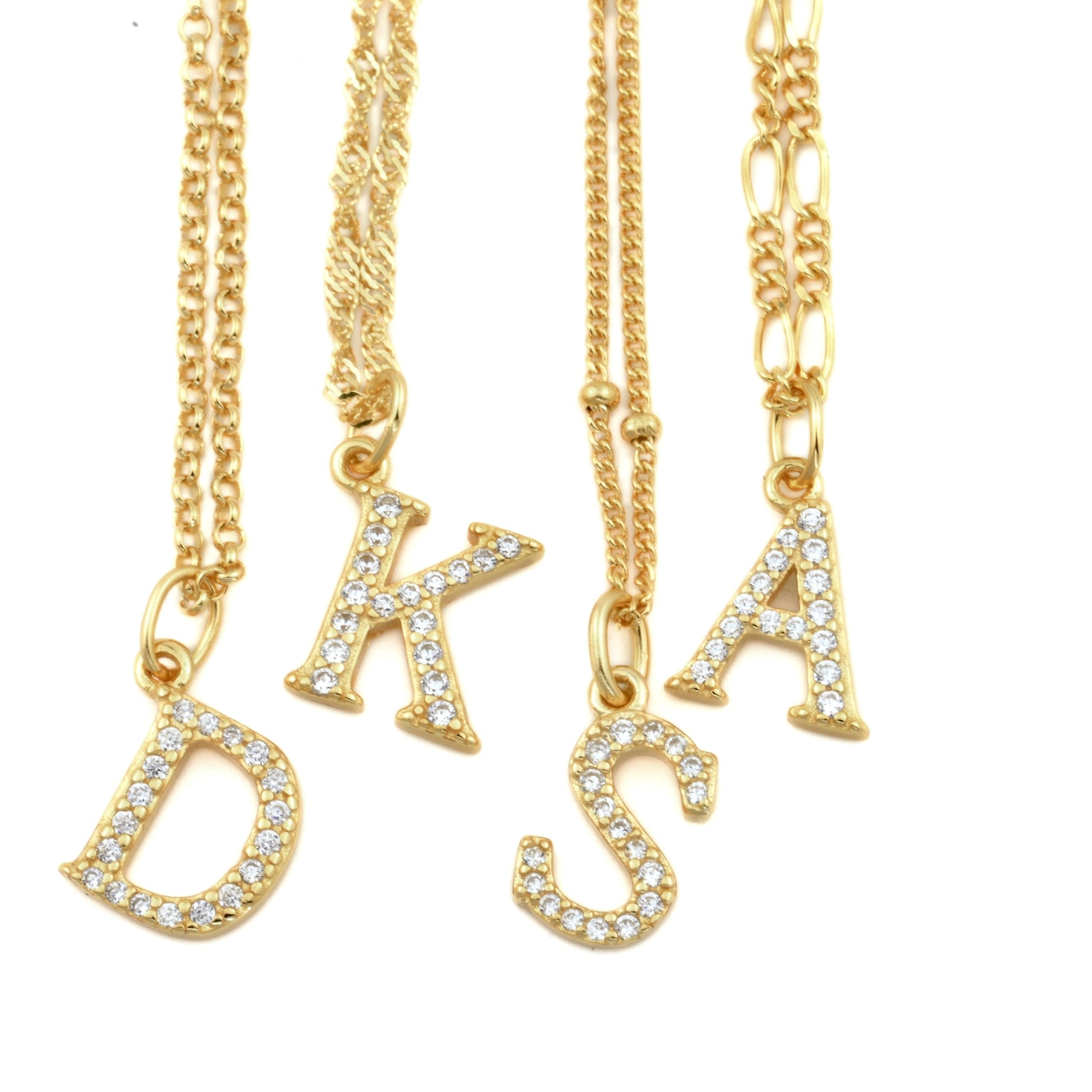 Gold necklaces with pave CZ initial charms on a white background