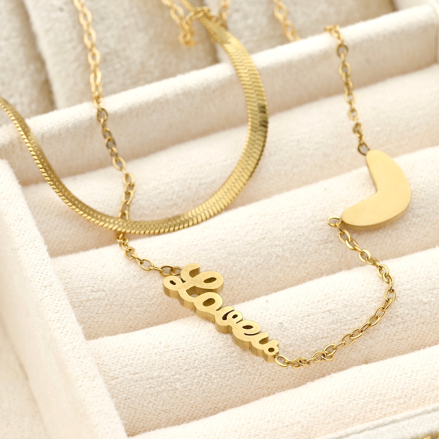 beige jewelry case view of the gold heart necklace set