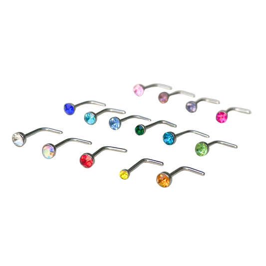 Set of nose rings with multicolored gemstones on a white background