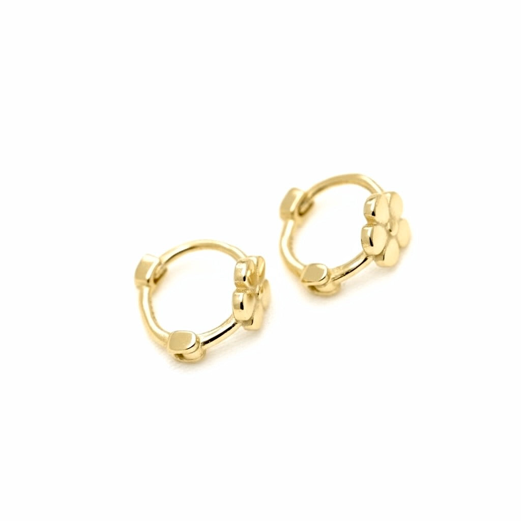 A pair of small gold huggie hoop earrings with textured bead details, shown on a clean white background.