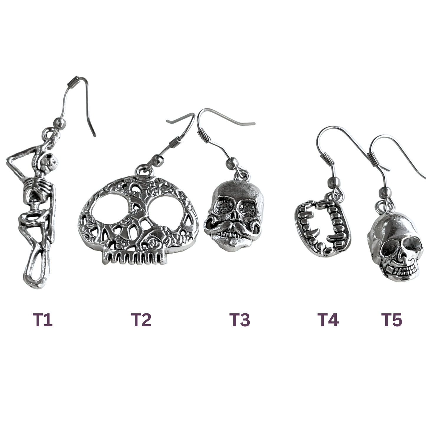 Set of five pairs of skull-themed earrings on a white background