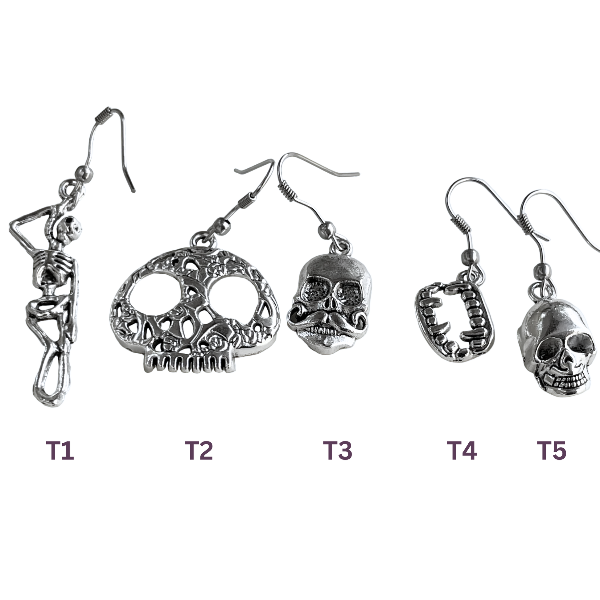 Set of five pairs of skull-themed earrings on a white background