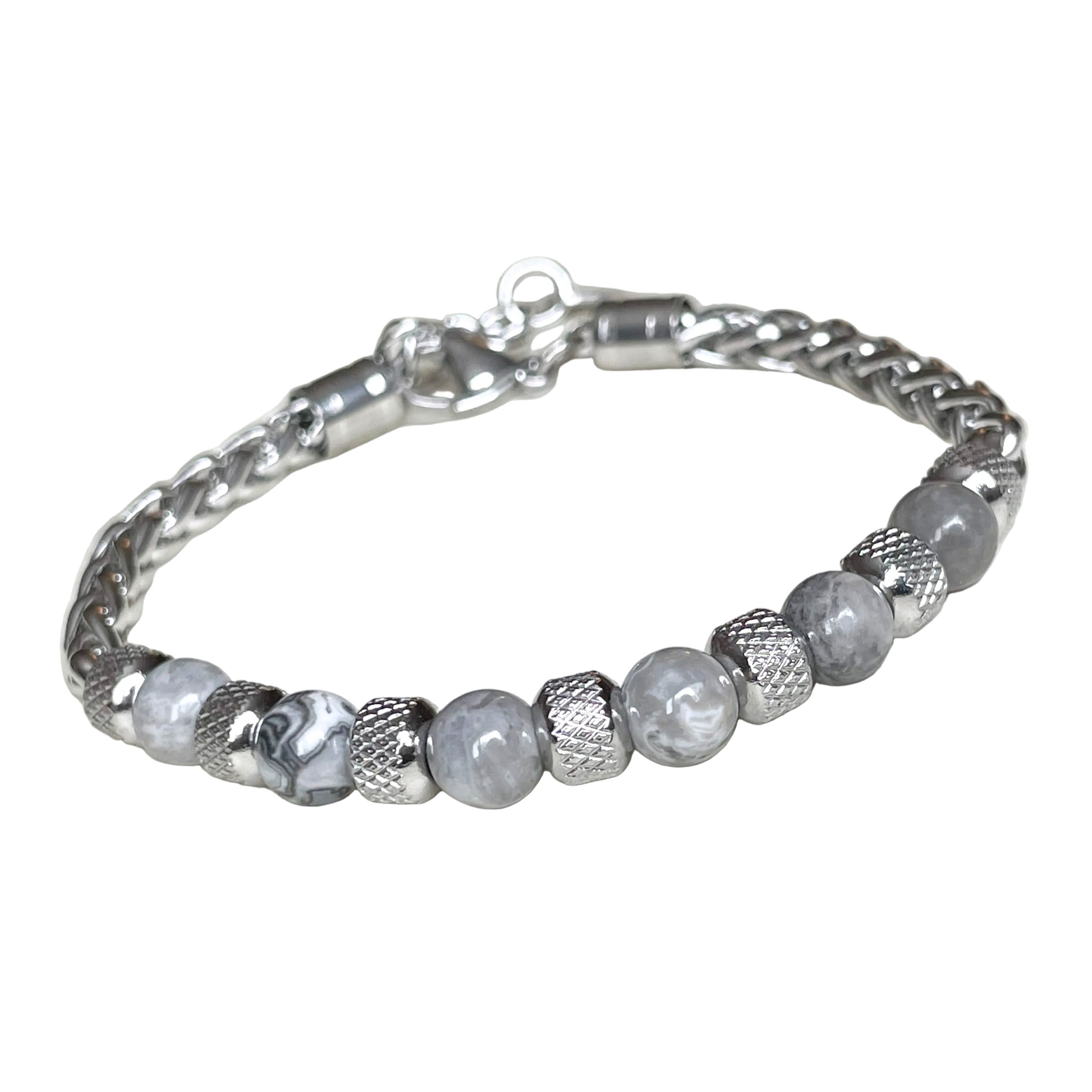 Thick silver wheat chain bracelet with textured steel beads and map stones on a white background