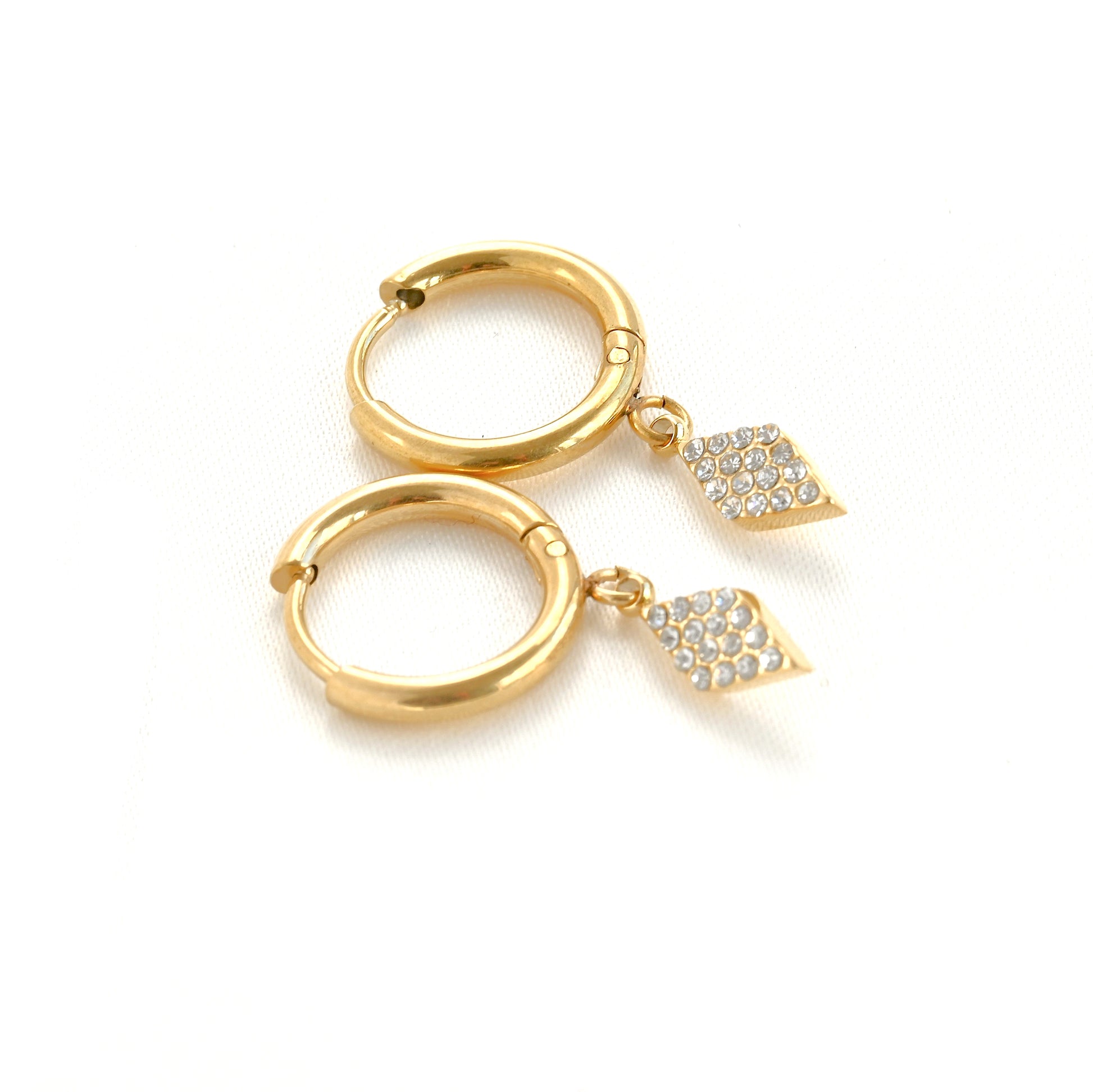 Gold rhombus-shaped hoop earrings with pave crystal accents on a white background