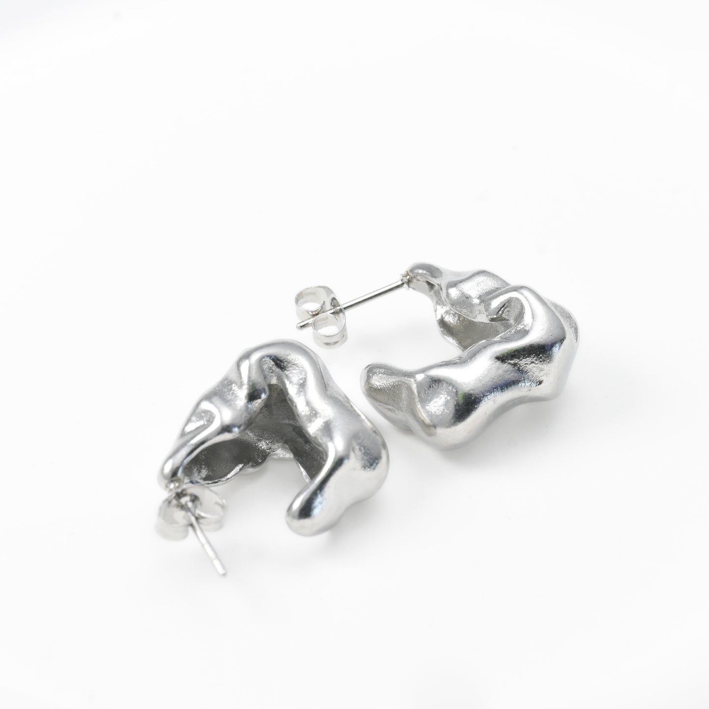 Silver abstract earrings on a white background