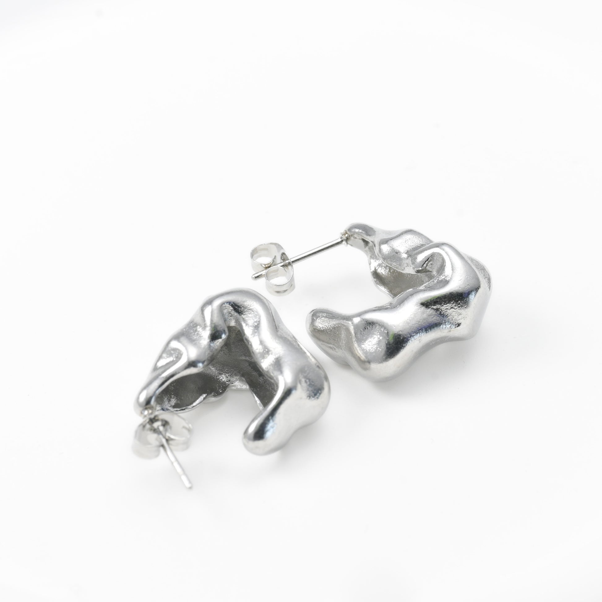 Silver abstract earrings on a white background