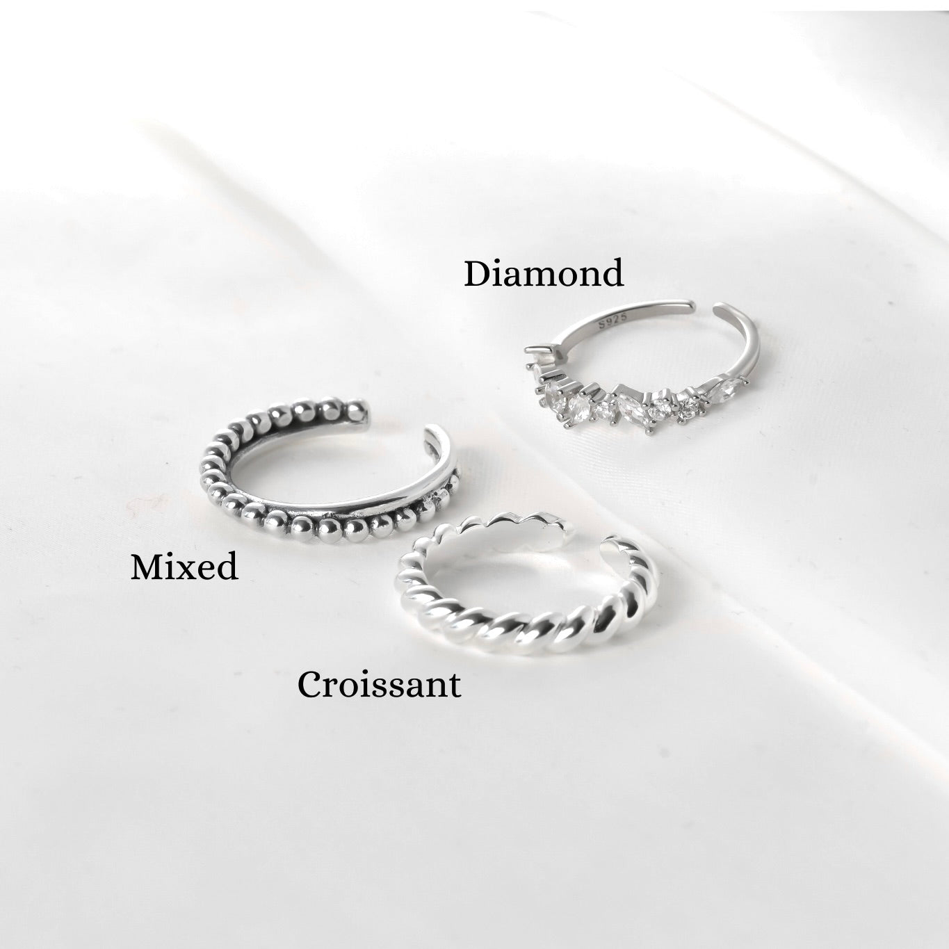 Three silver hoop earrings labeled 'Diamond', 'Mixed', and 'Croissant' on a white background.