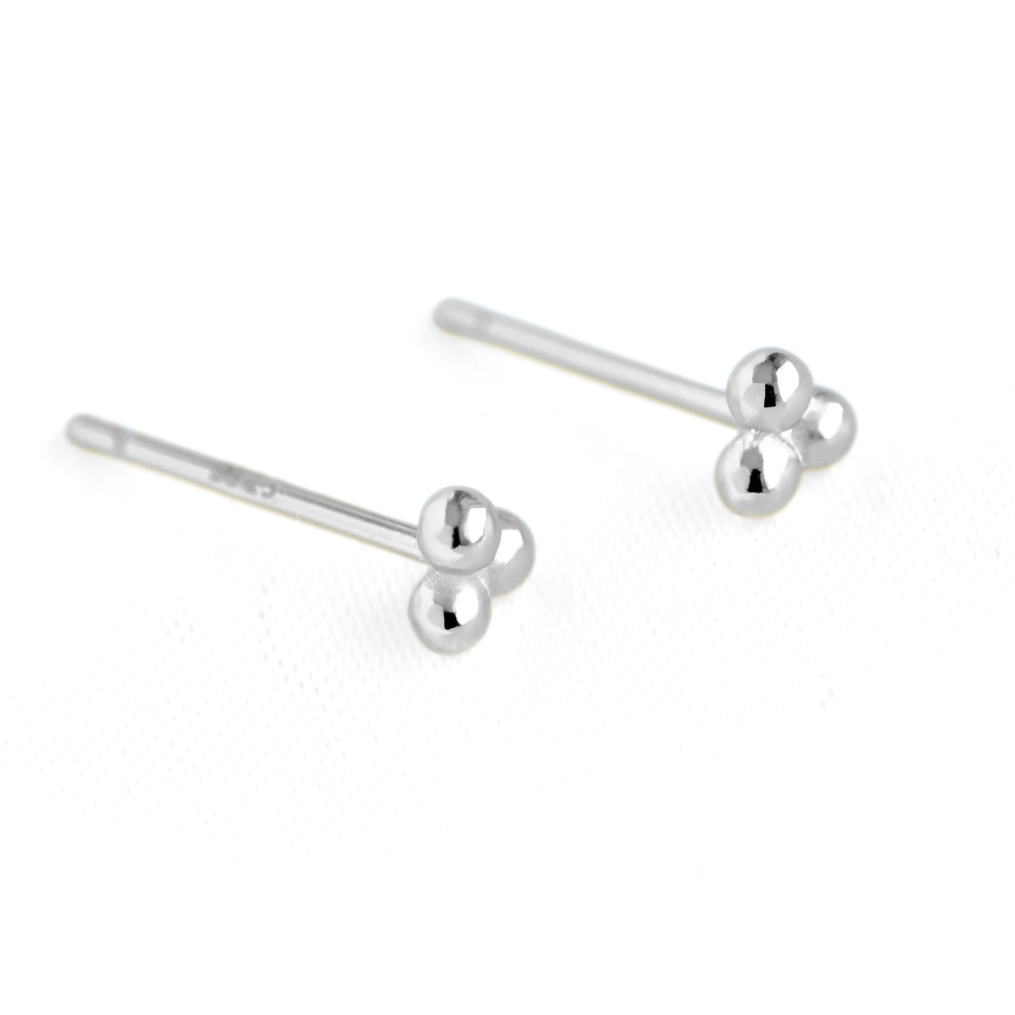 A pair of silver sphere cluster stud earrings with three small polished spherical beads at the end, displayed on a clean white background.