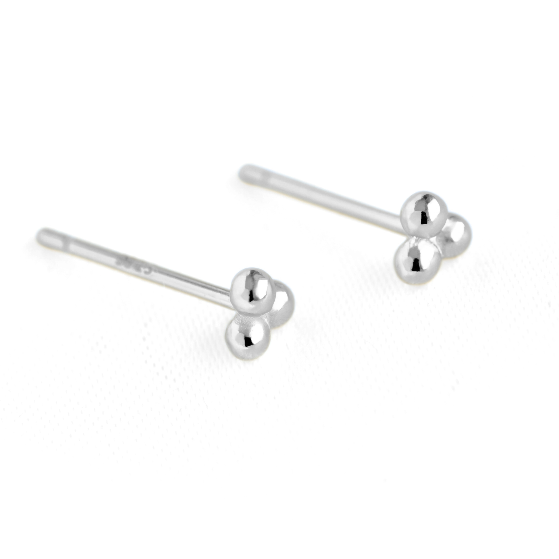 A pair of silver sphere cluster stud earrings with three small polished spherical beads at the end, displayed on a clean white background.