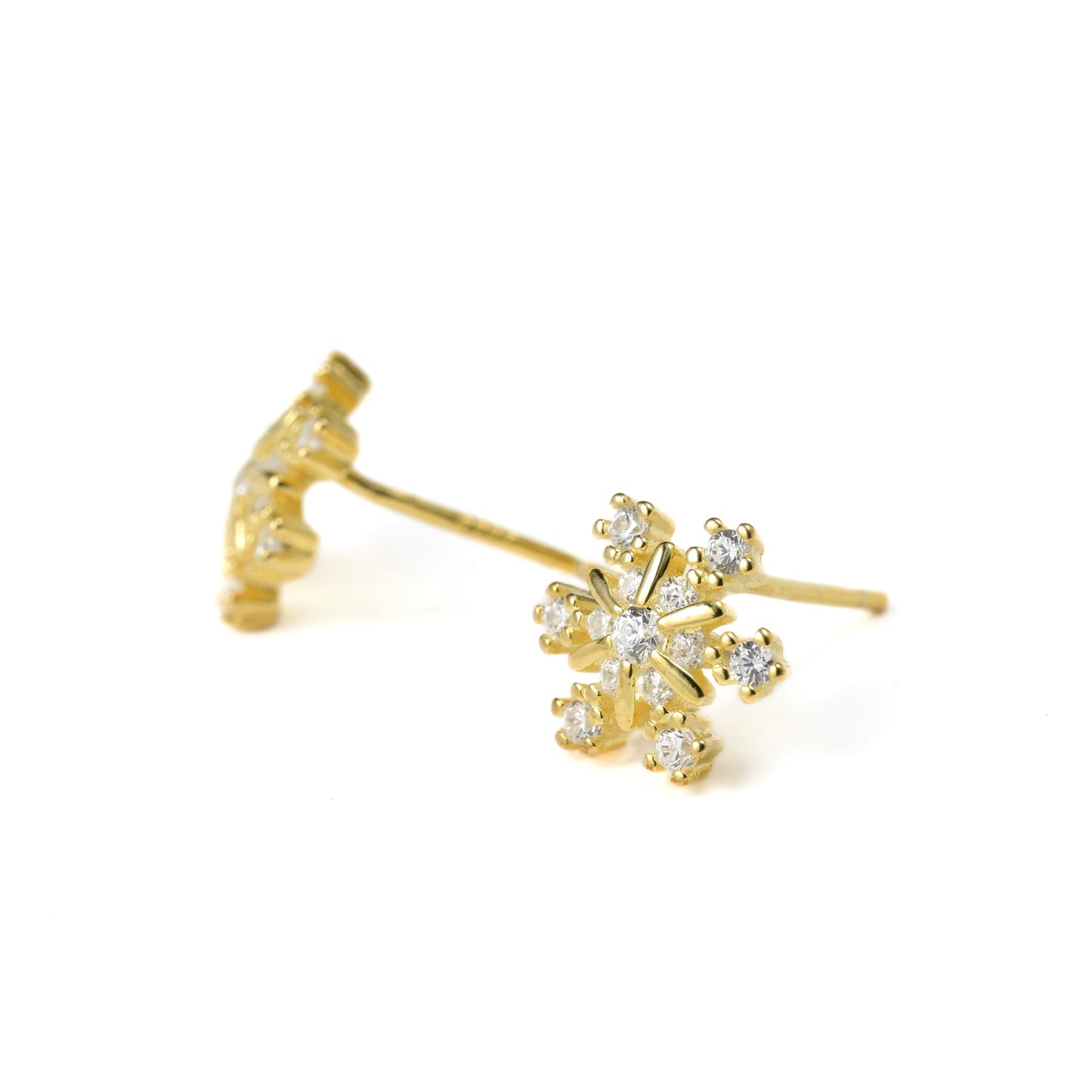 Gold earrings with diamond-like stones on a white background