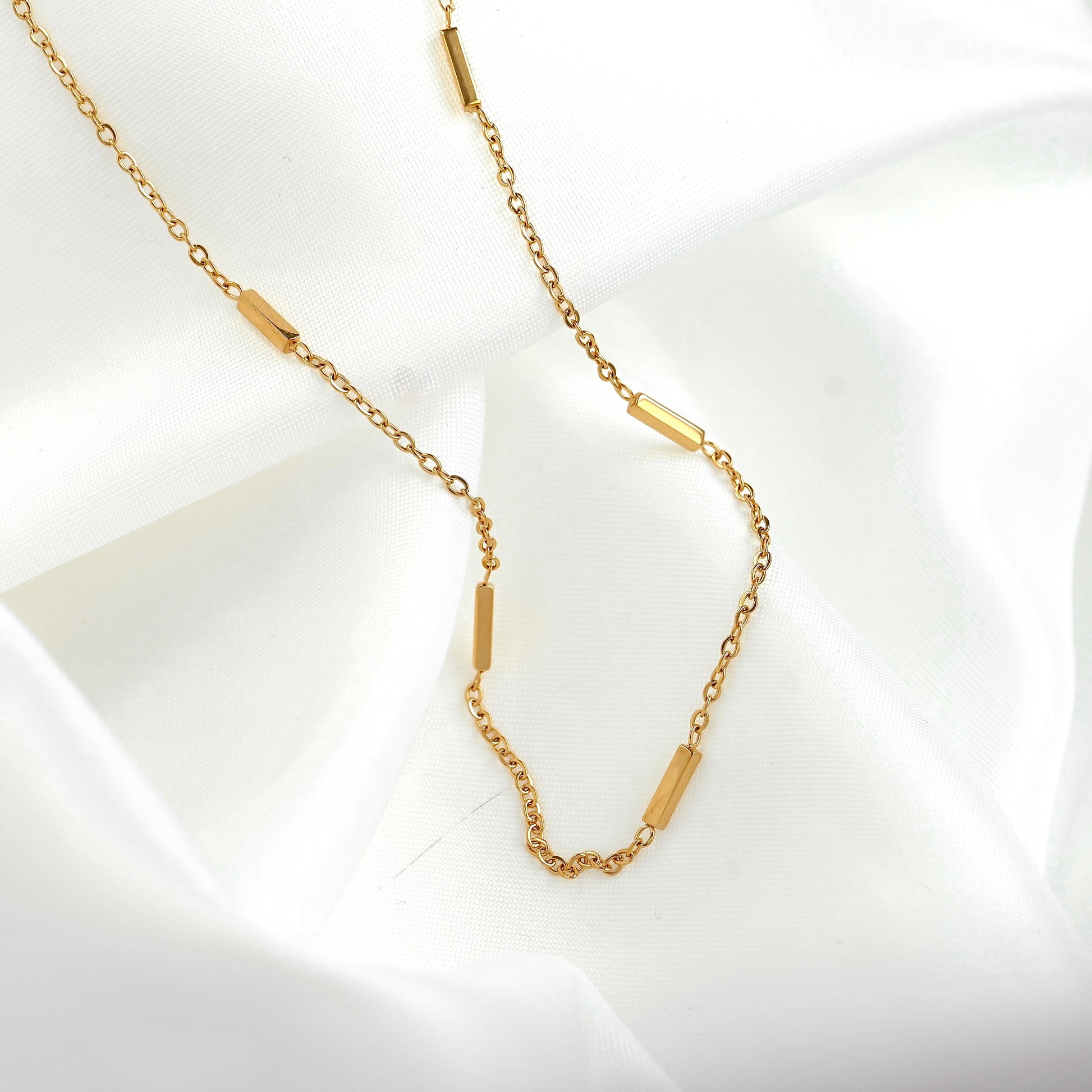 Gold chain necklace on a white background