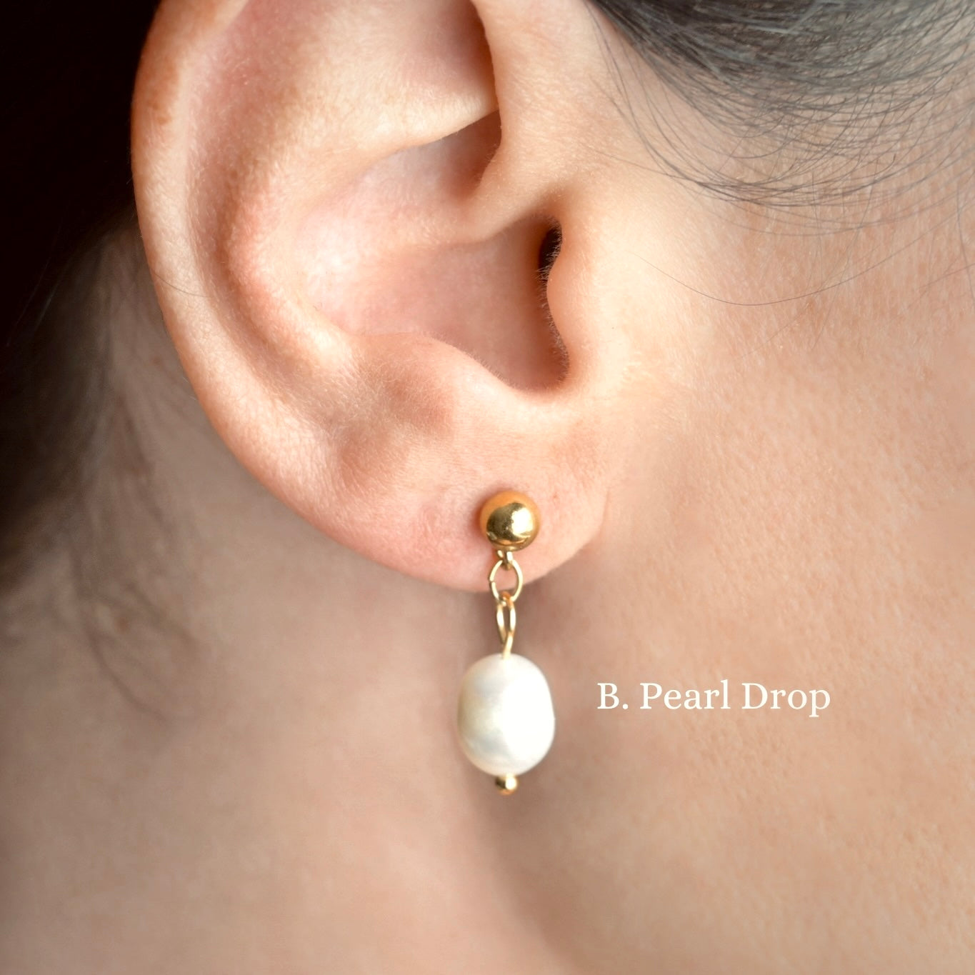 Gold Pearl drop earring worn on an ear with 'B. Pearl Drop' branding.