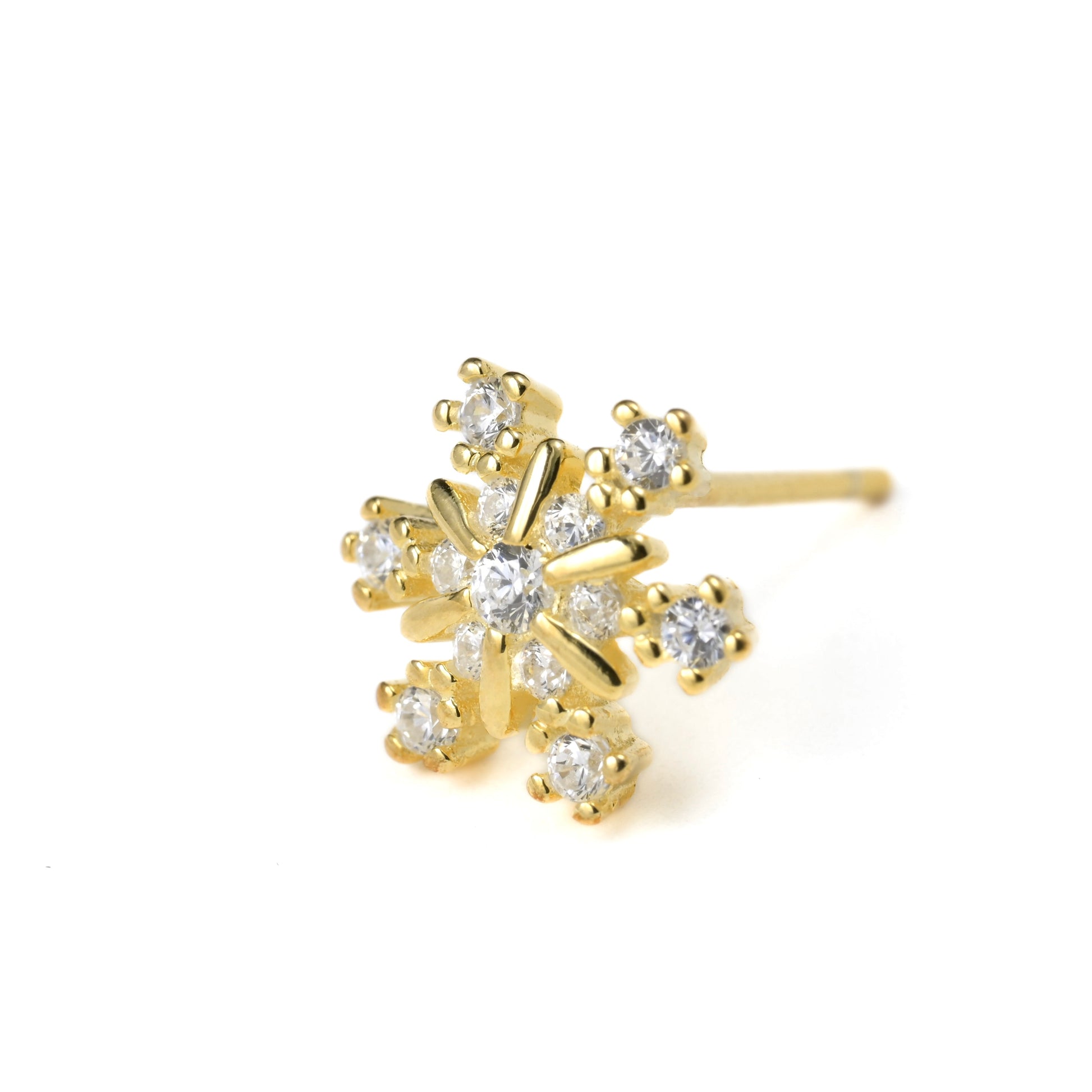 close-up of  a gold snowflake stud earring with clear gemstones on a white background