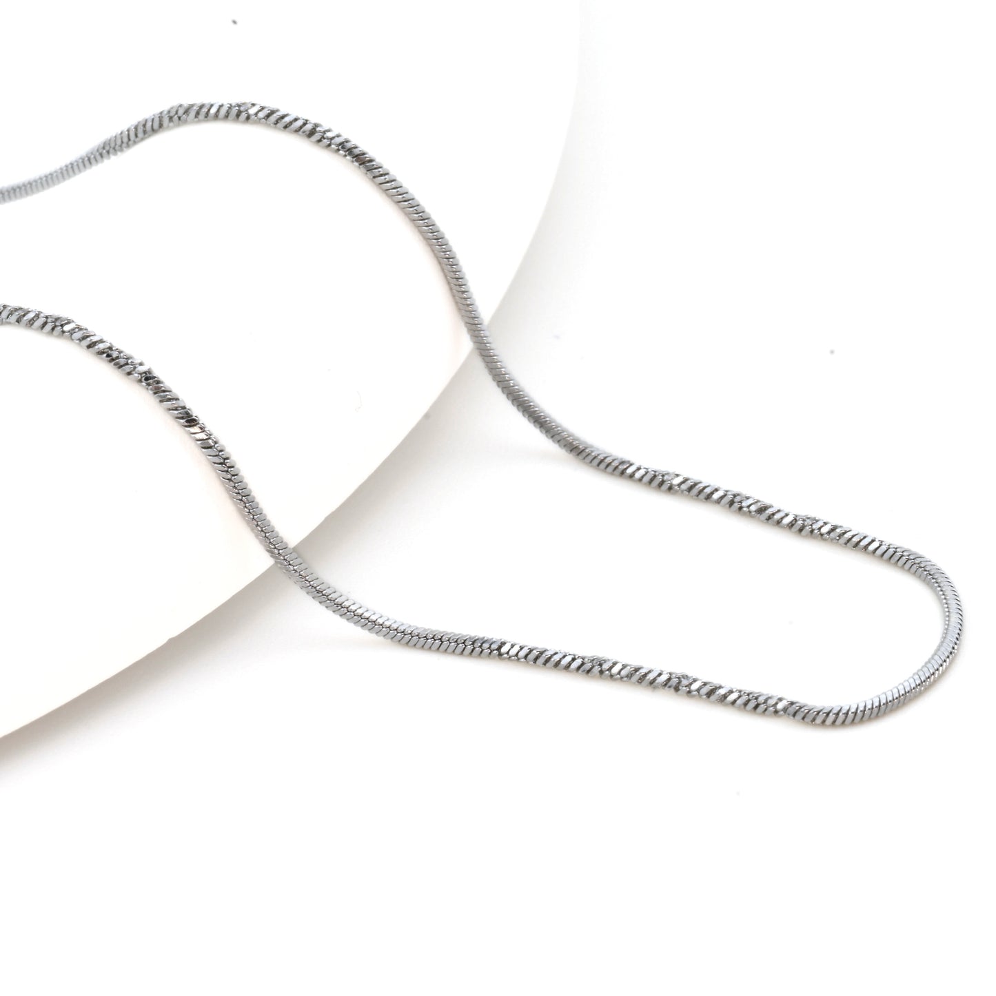 Silver snake necklace on a white background