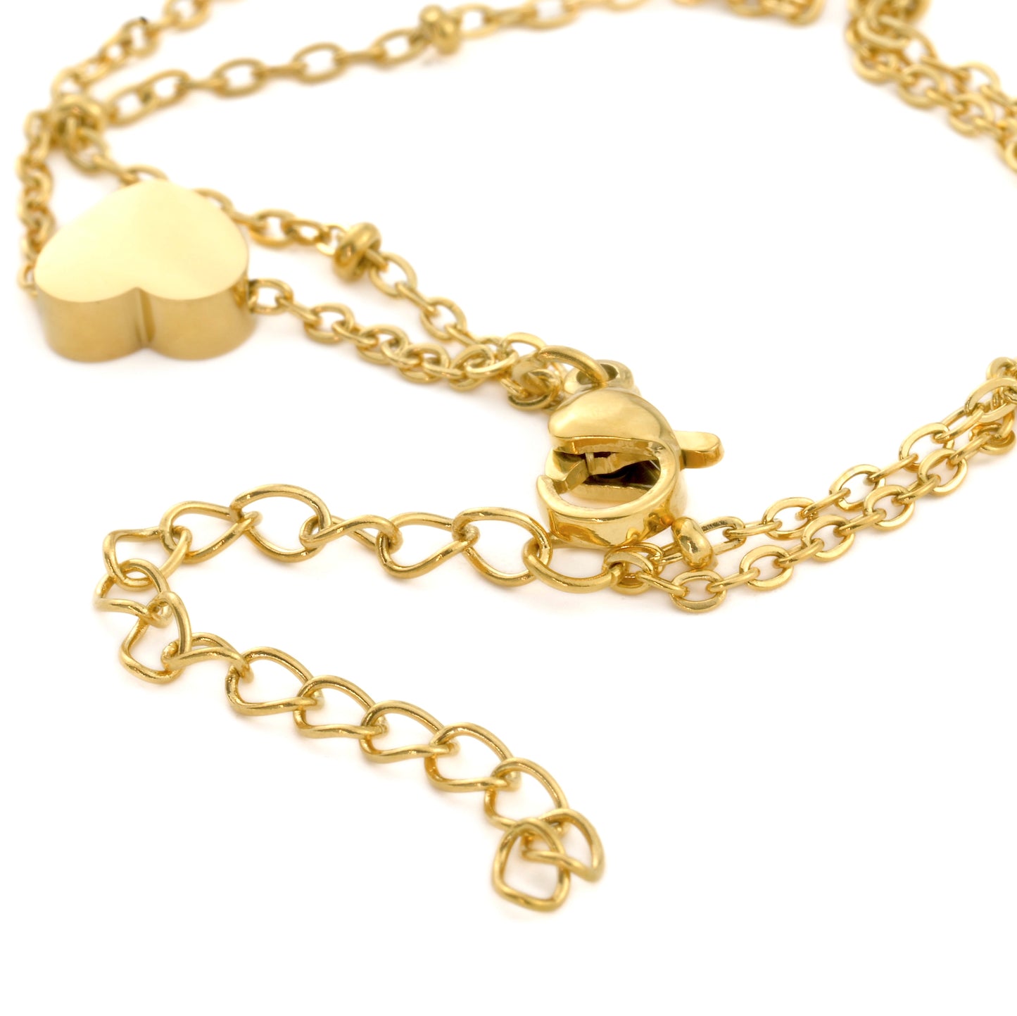 Gold chain ankle bracelet with heart-shaped charm, lobster claw clasp and extender on a white background