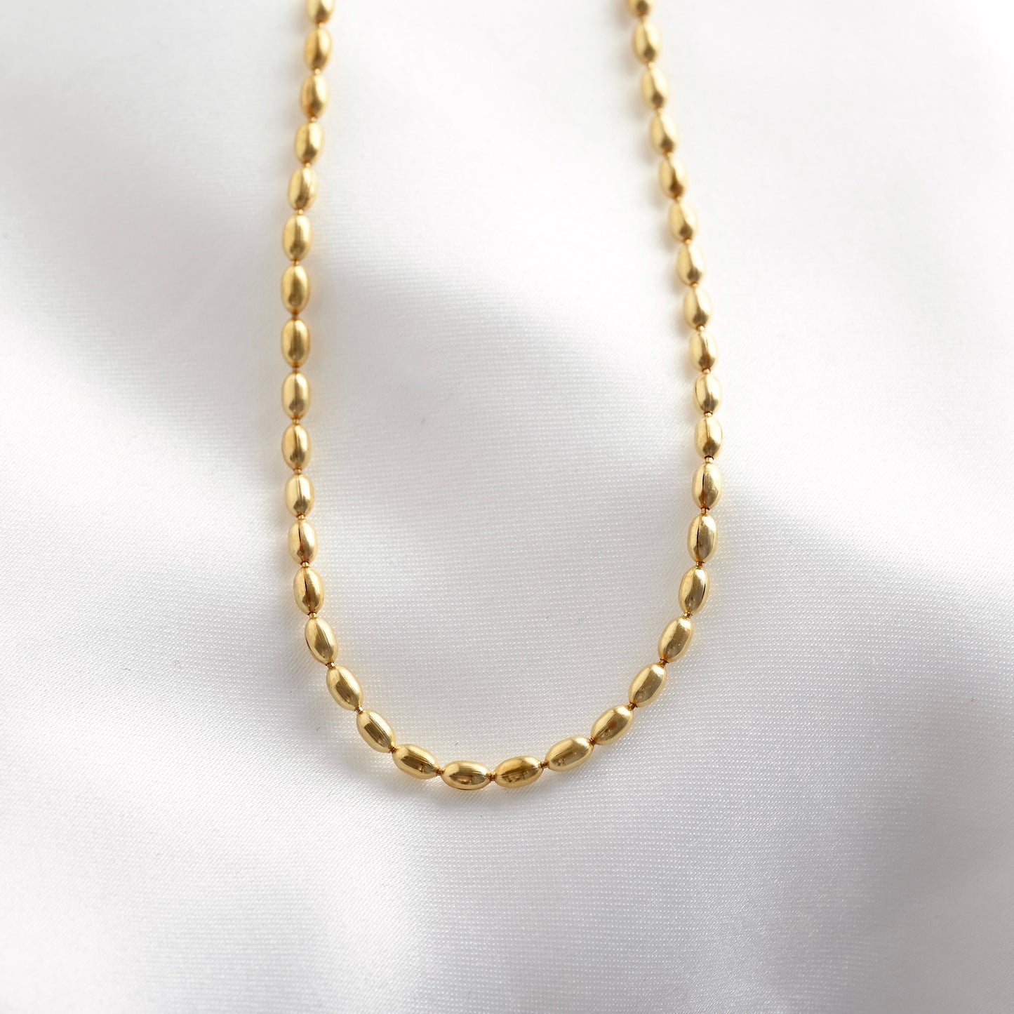 Gold chain necklace on a white background