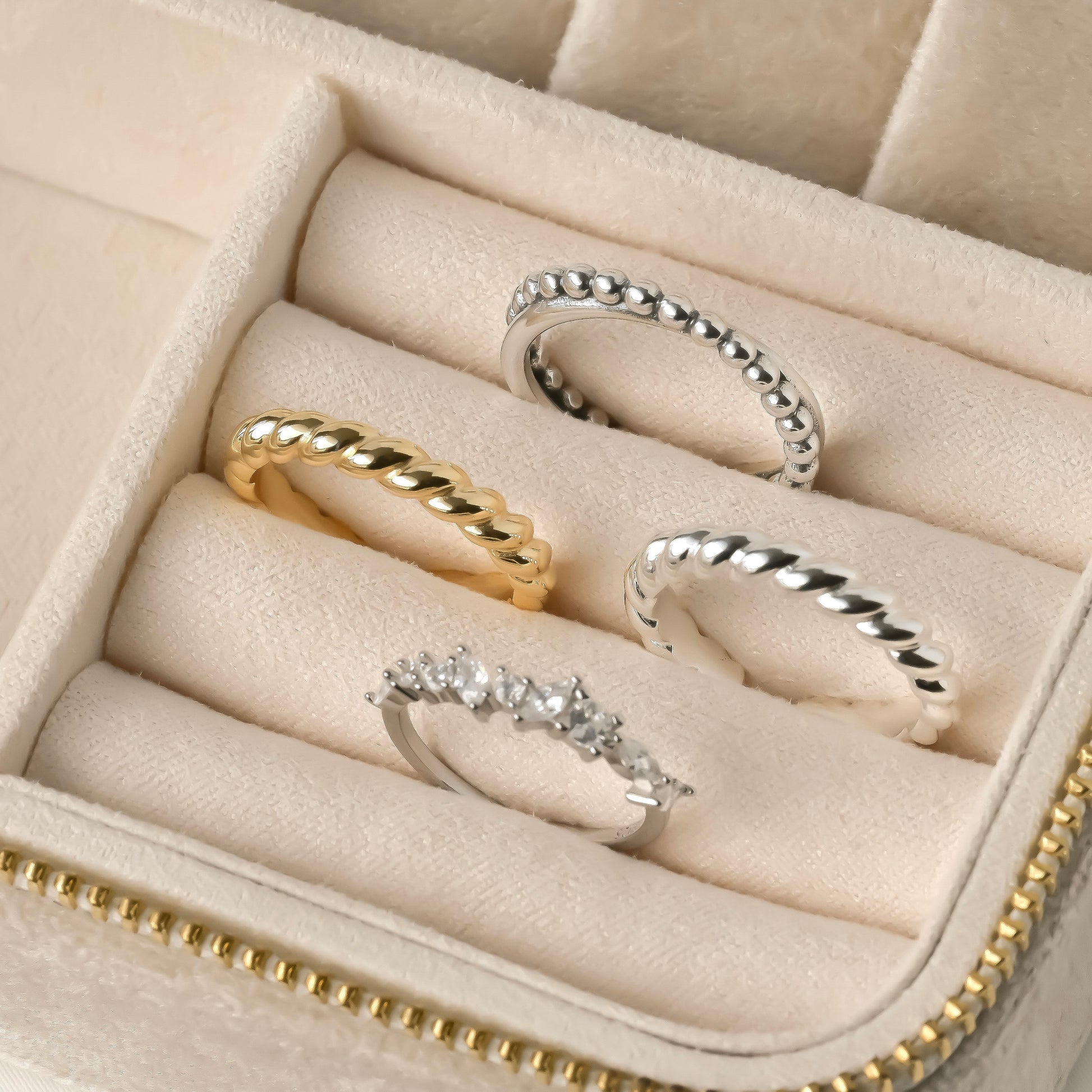 Set of gold and silver rings in a jewelry box