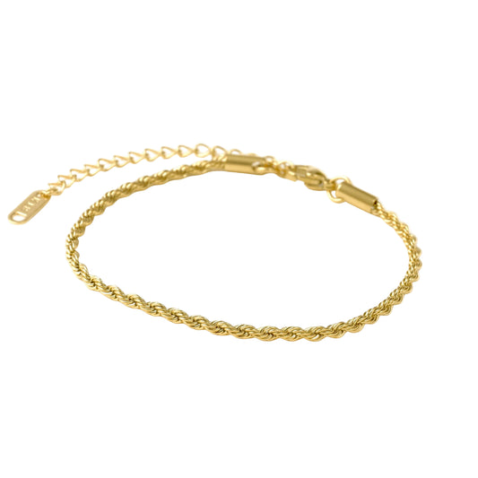 Dainty gold rope bracelet on a white background