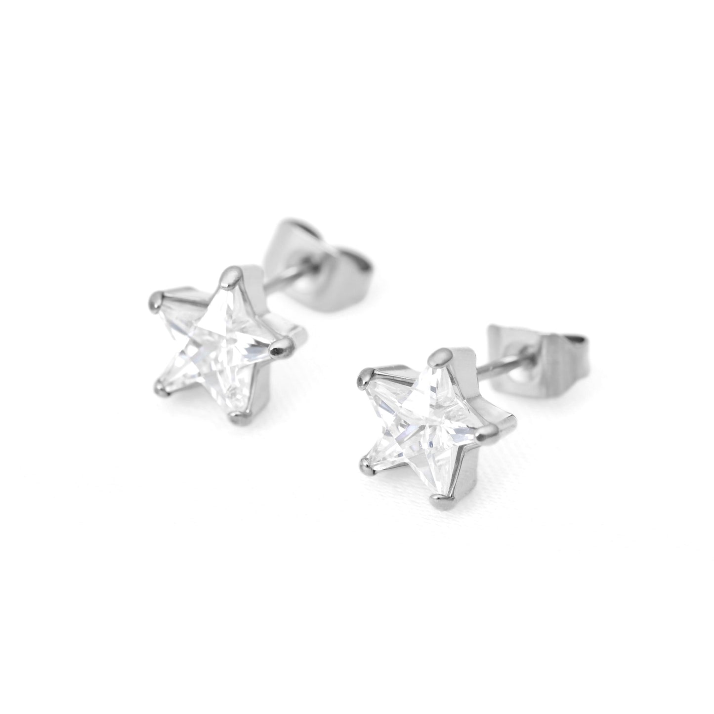 A pair of silver star-shaped stud earrings with clear star-cut cubic zirconia, shown on a plain white background.