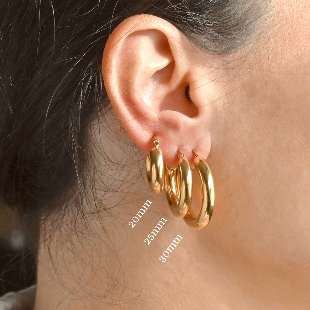 Small Gold hoop earrings worn by a person, with measurements indicated.
