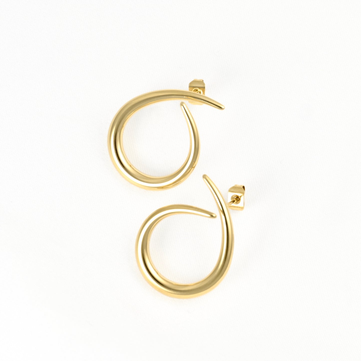 A pair of gold-toned, open spiral hoop earrings with push-back closures, displayed on a clean white background.