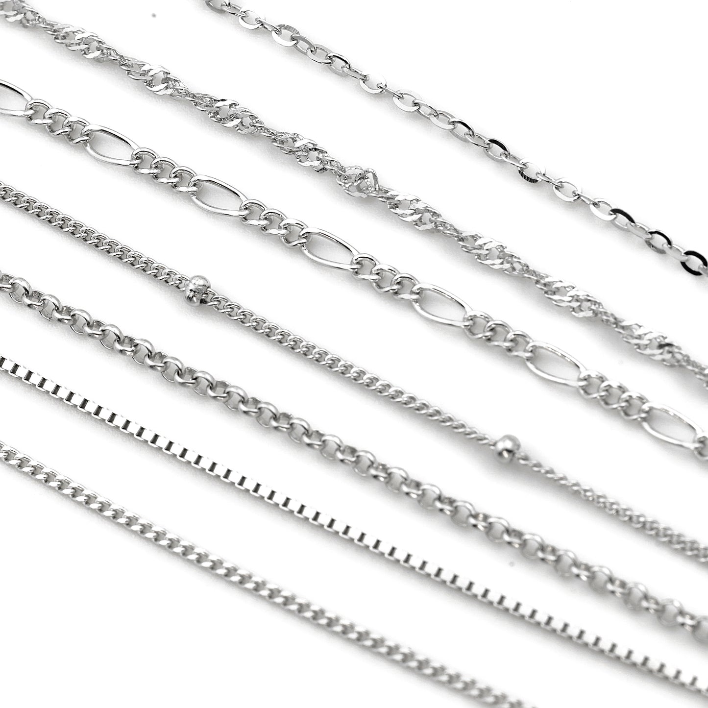 Collection of silver chains on a white background
