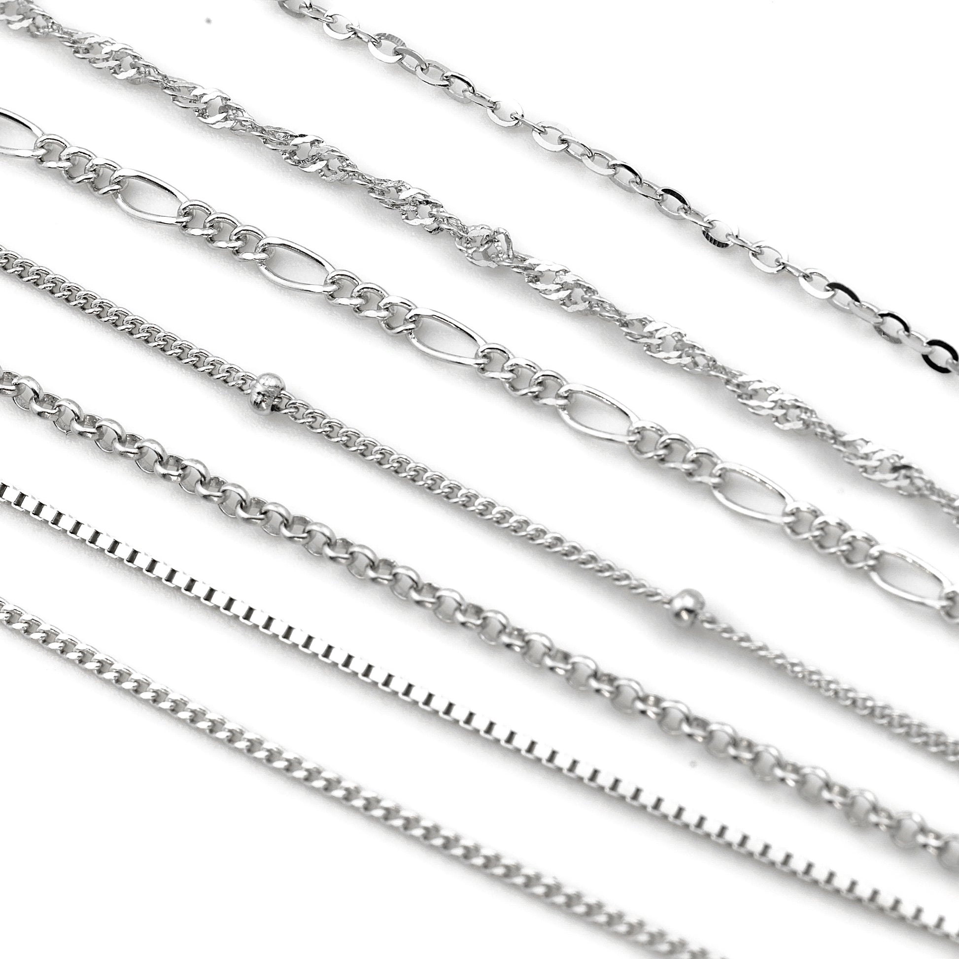 Collection of silver chains on a white background
