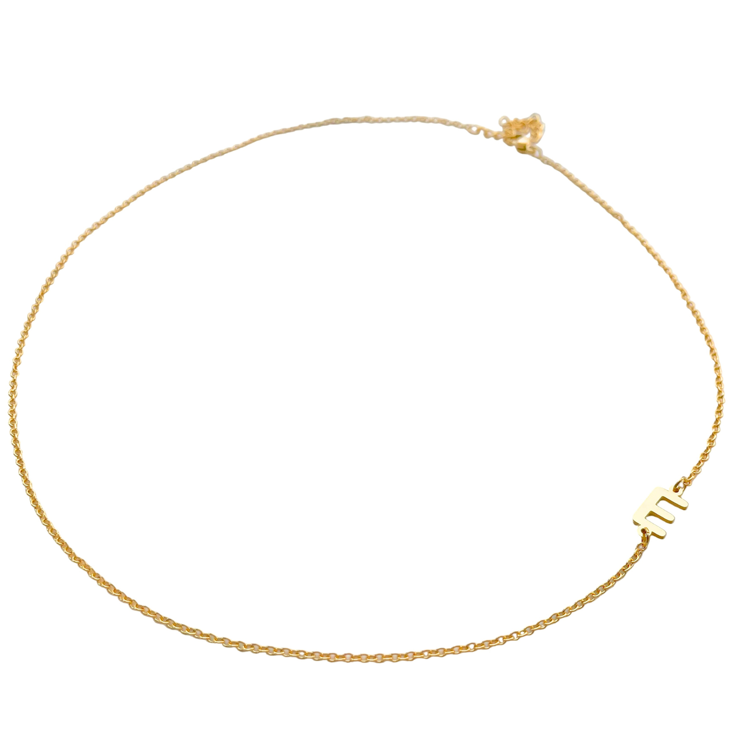 Wide angled view of gold initial necklace on a white background, the entire necklace being in frame