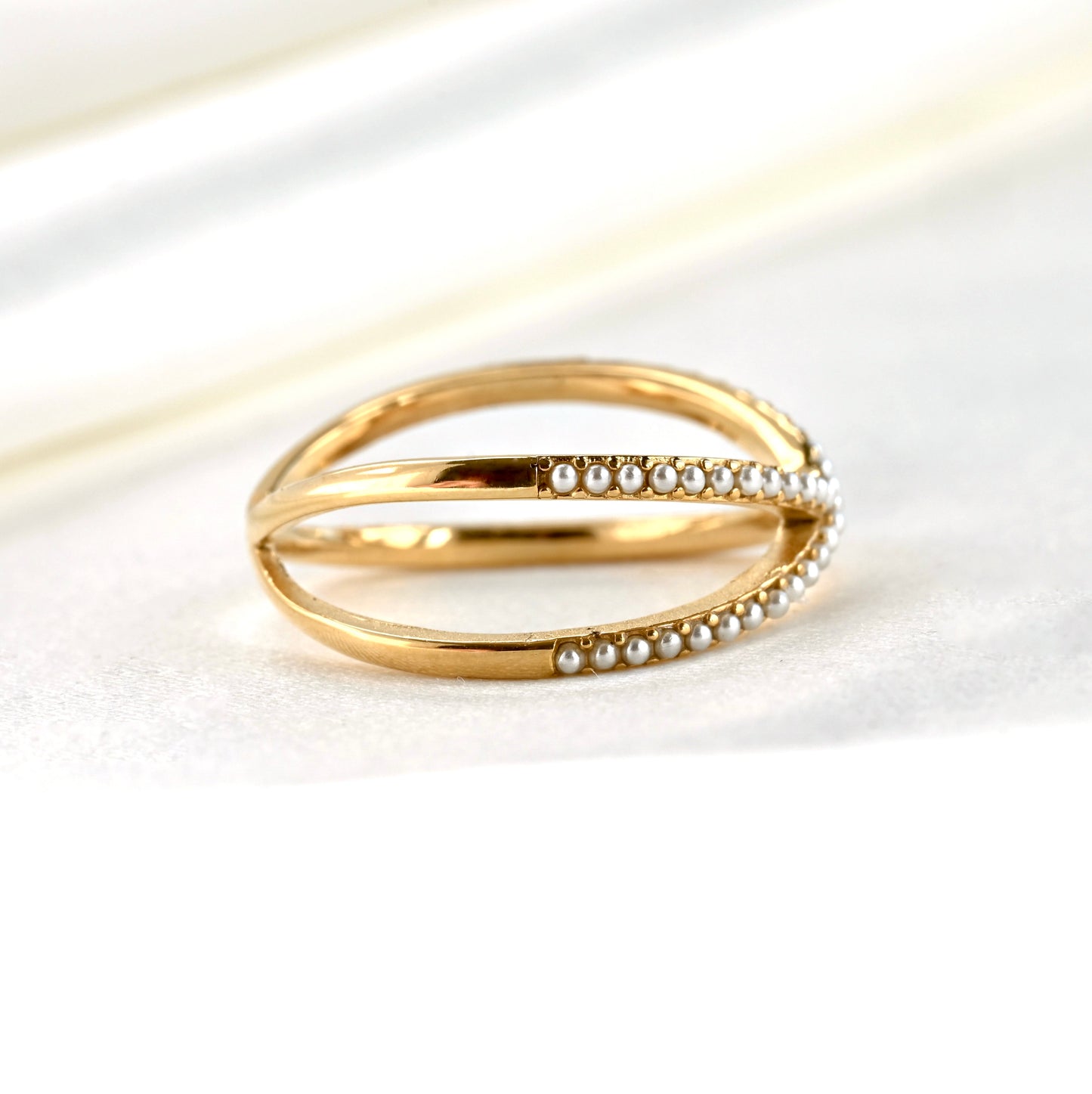 Right side view of the gold ring with pearl accents on a white background