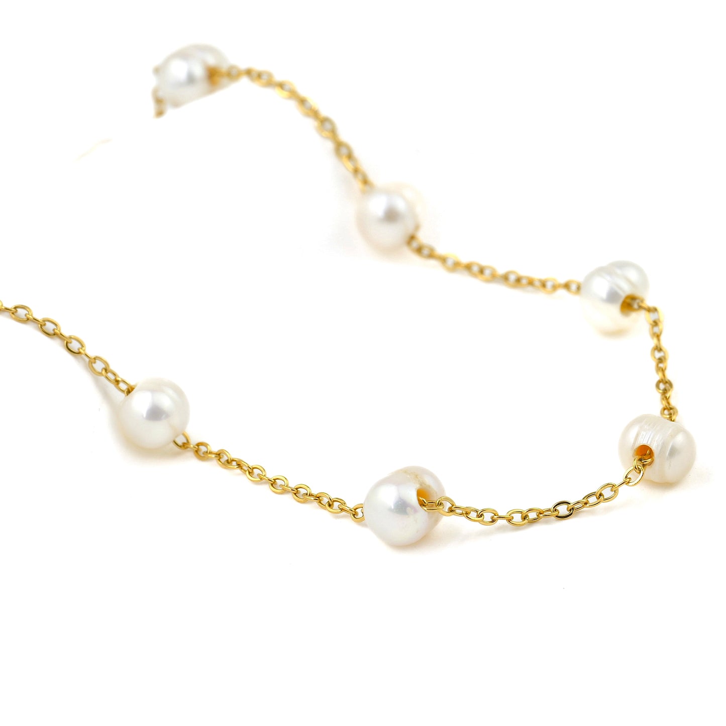 Gold chain necklace with pearl stations on a white background