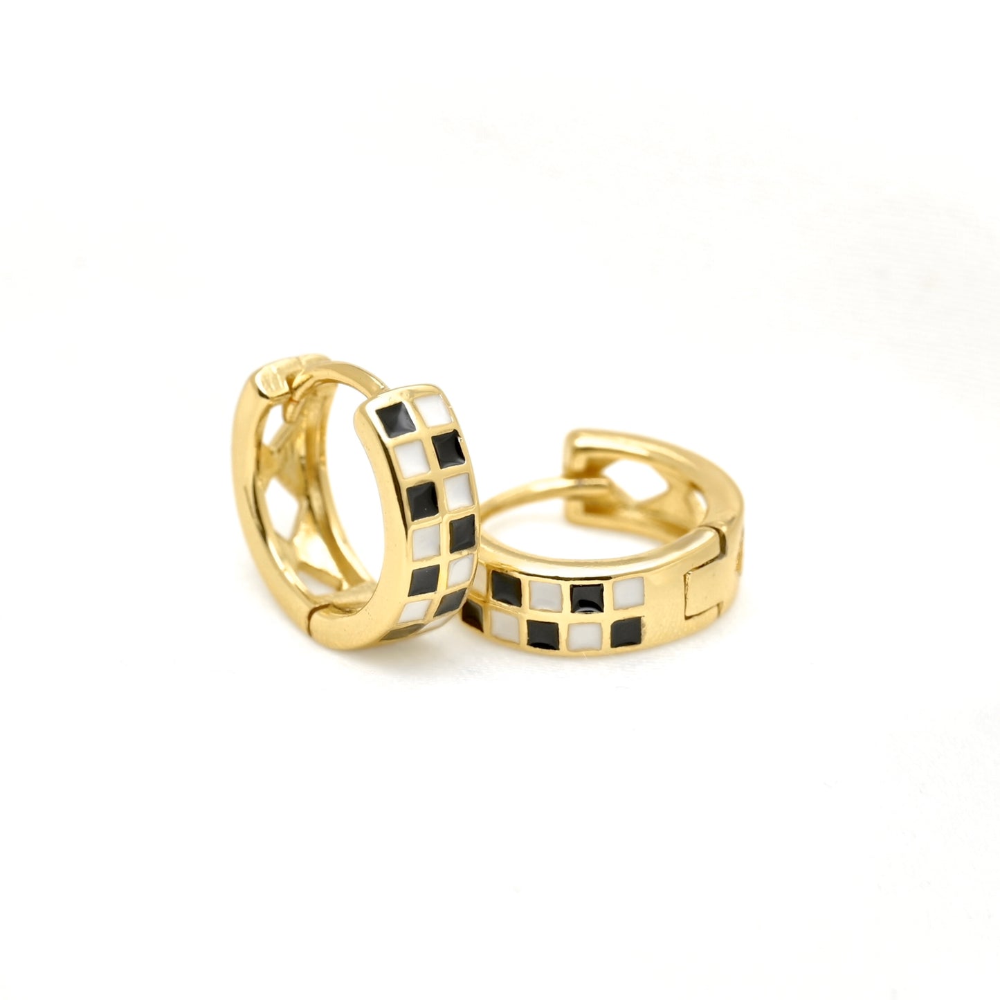 Gold hoop earrings with black and white checkered pattern on a white background