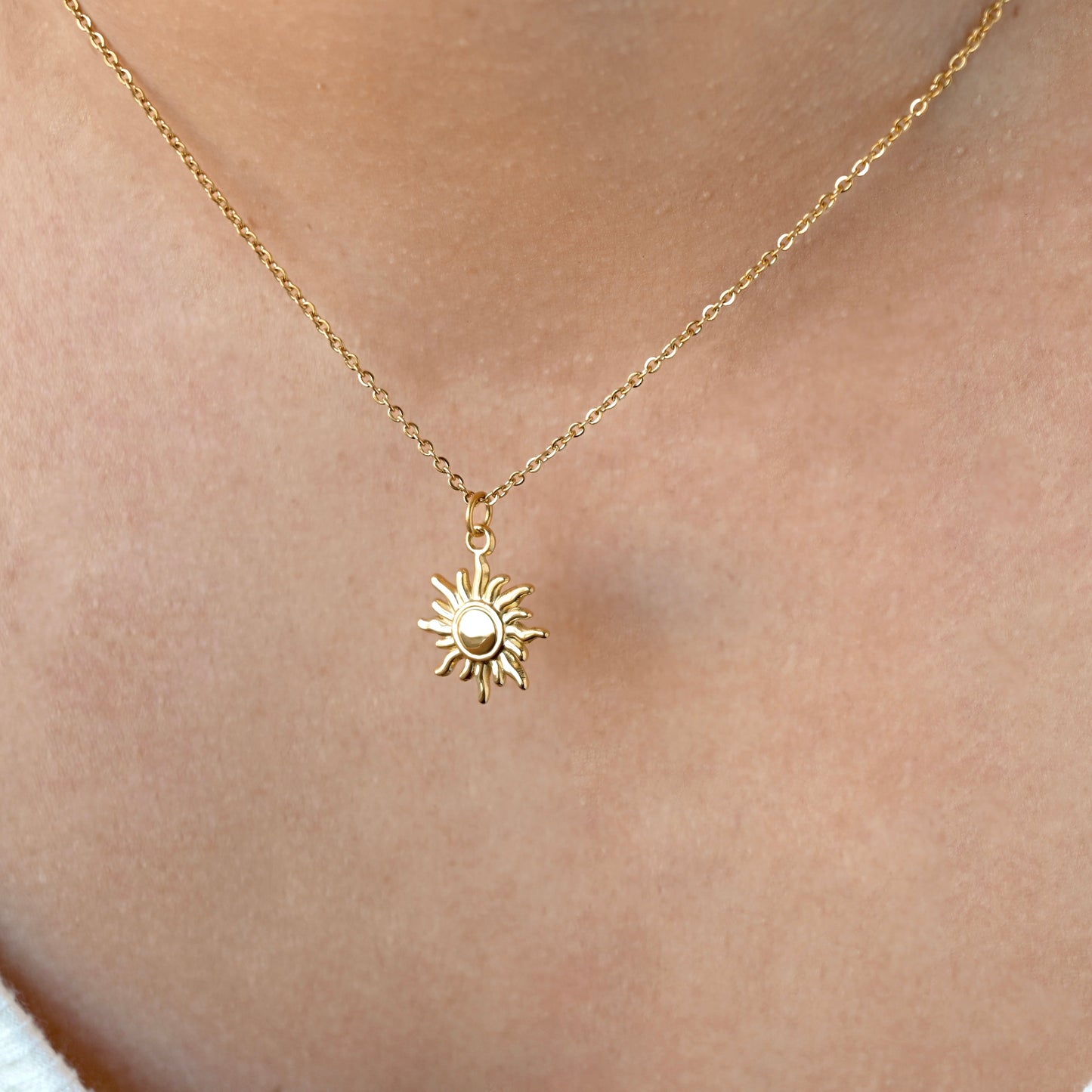 Gold dun necklace with on a person's neck