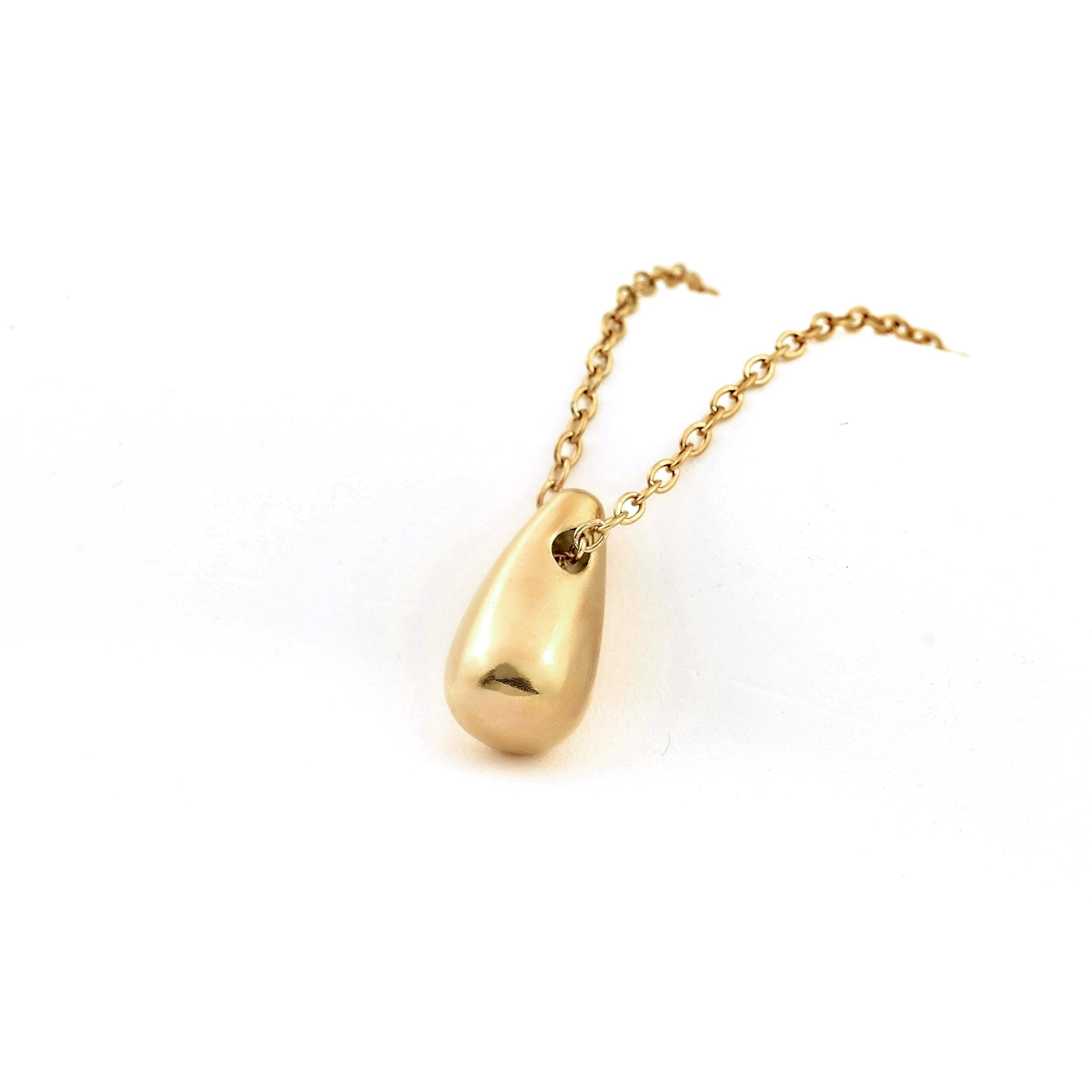 Gold necklace with a teardrop-shaped pendant on a white background