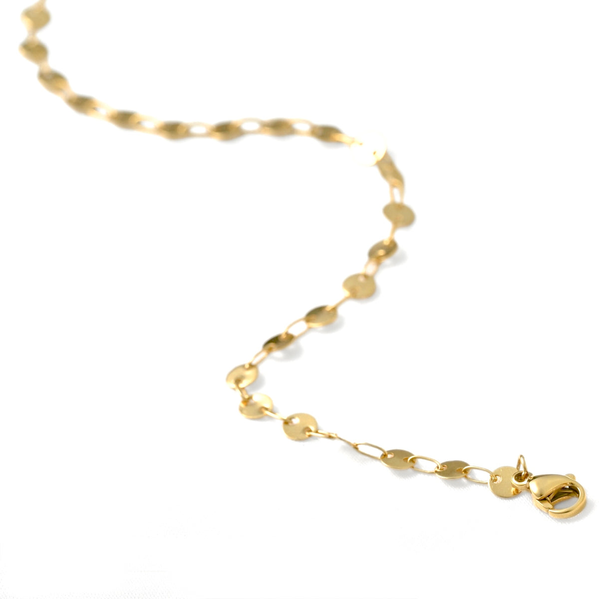 A gold chain necklace with flat, oval disc-like links and a lobster clasp, photographed on a clean white background.