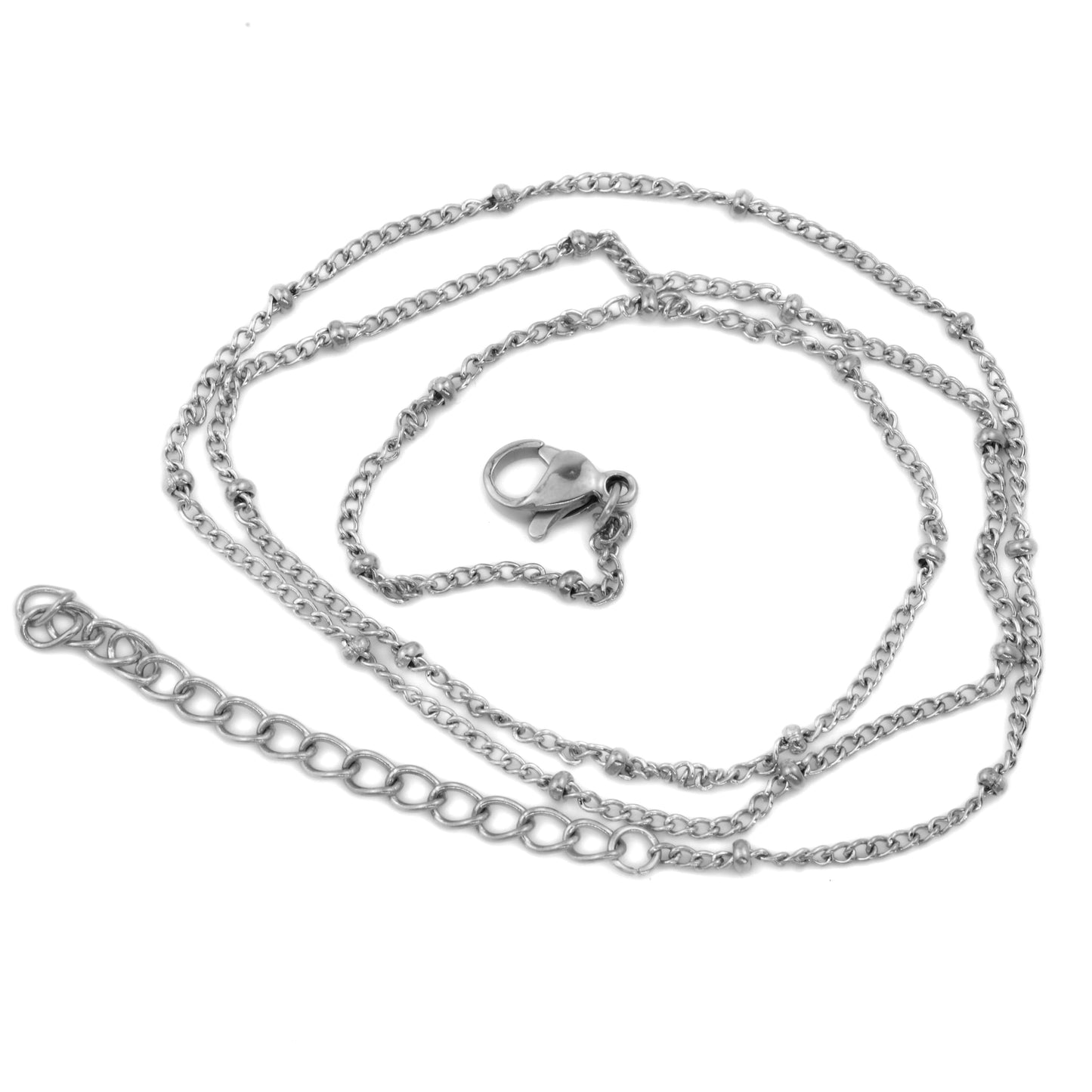 Silver layering chain necklace on a white background