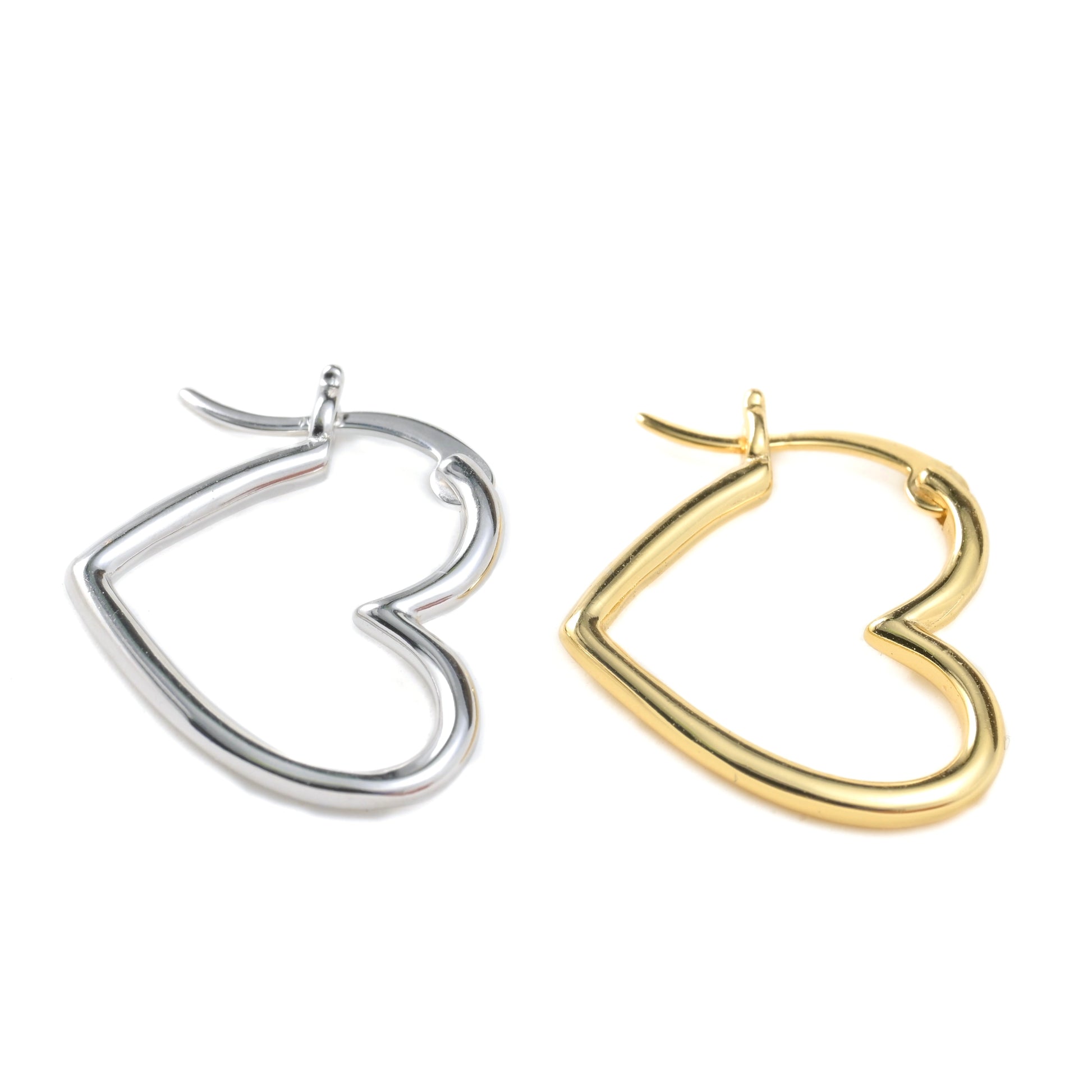 Sideways open heart hoop earrings in gold and silver on a white background
