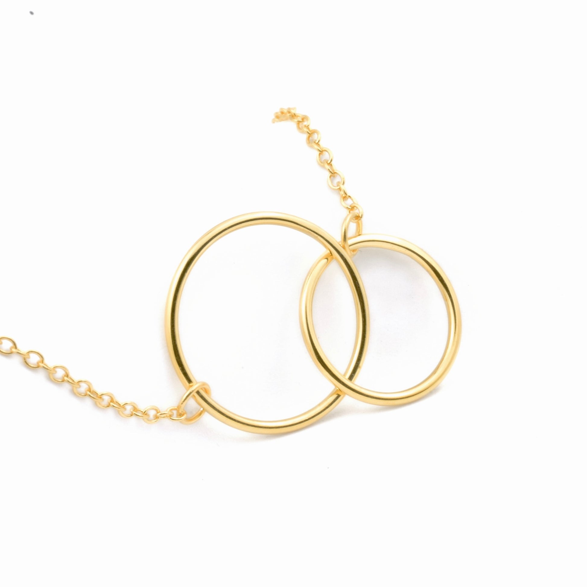 Gold entwined hoop necklace on a white background