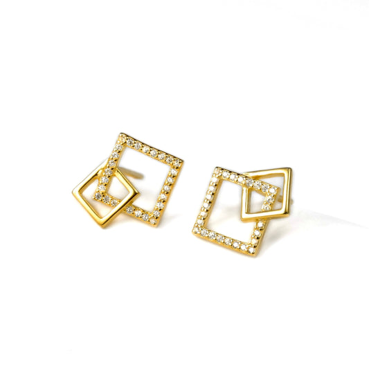 Gold square earrings with embedded stones on a white background