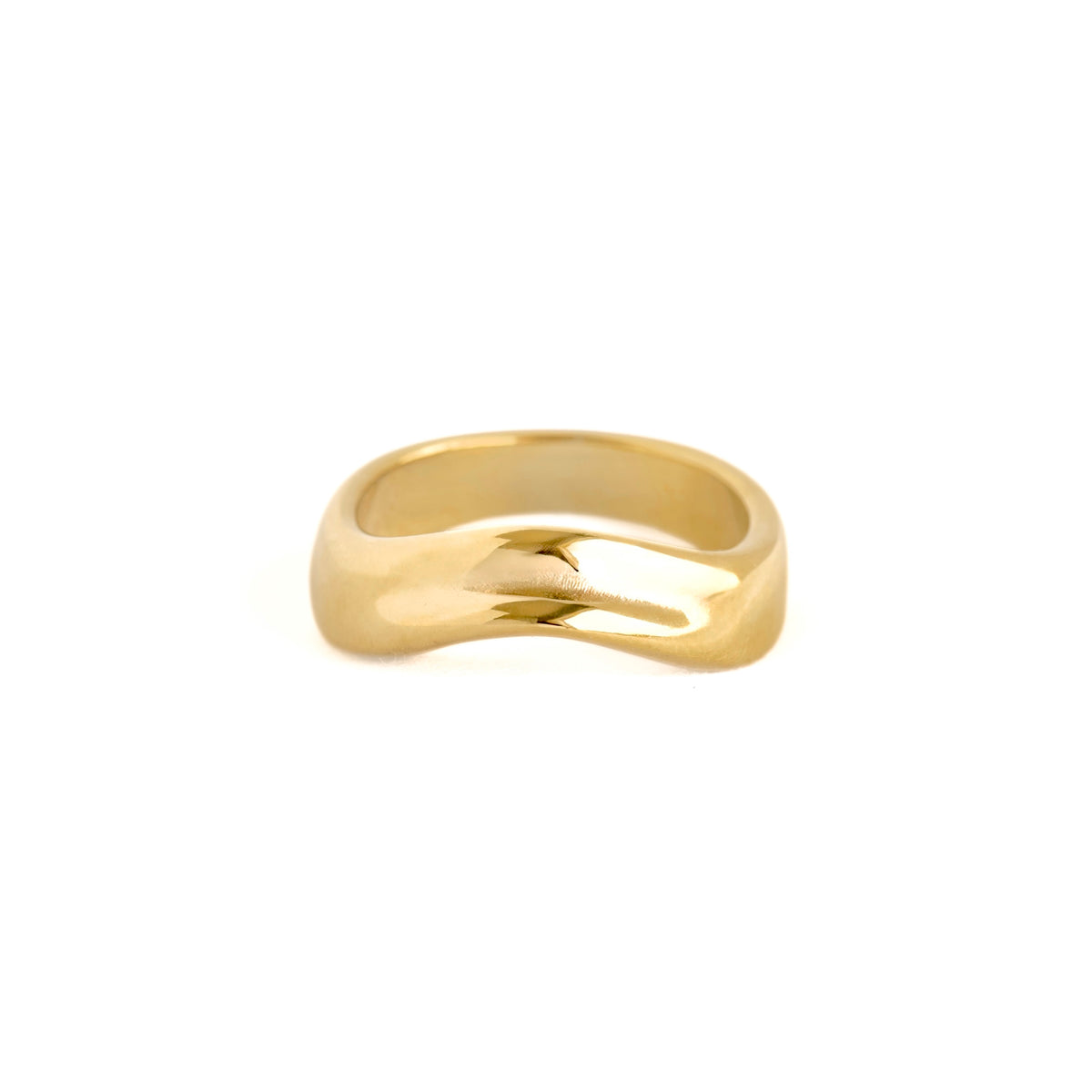 A polished yellow gold ring with a smooth, wavy, fluid-like organic shape, photographed on a seamless white background.