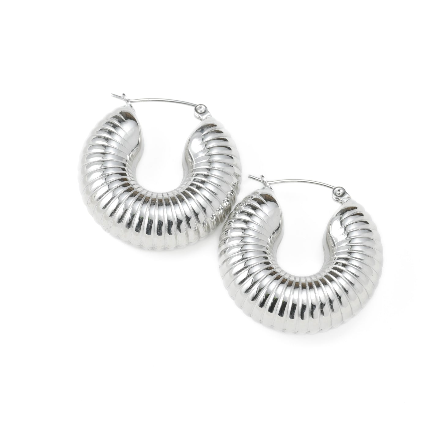 Thick textured silver hoop earrings on a white background